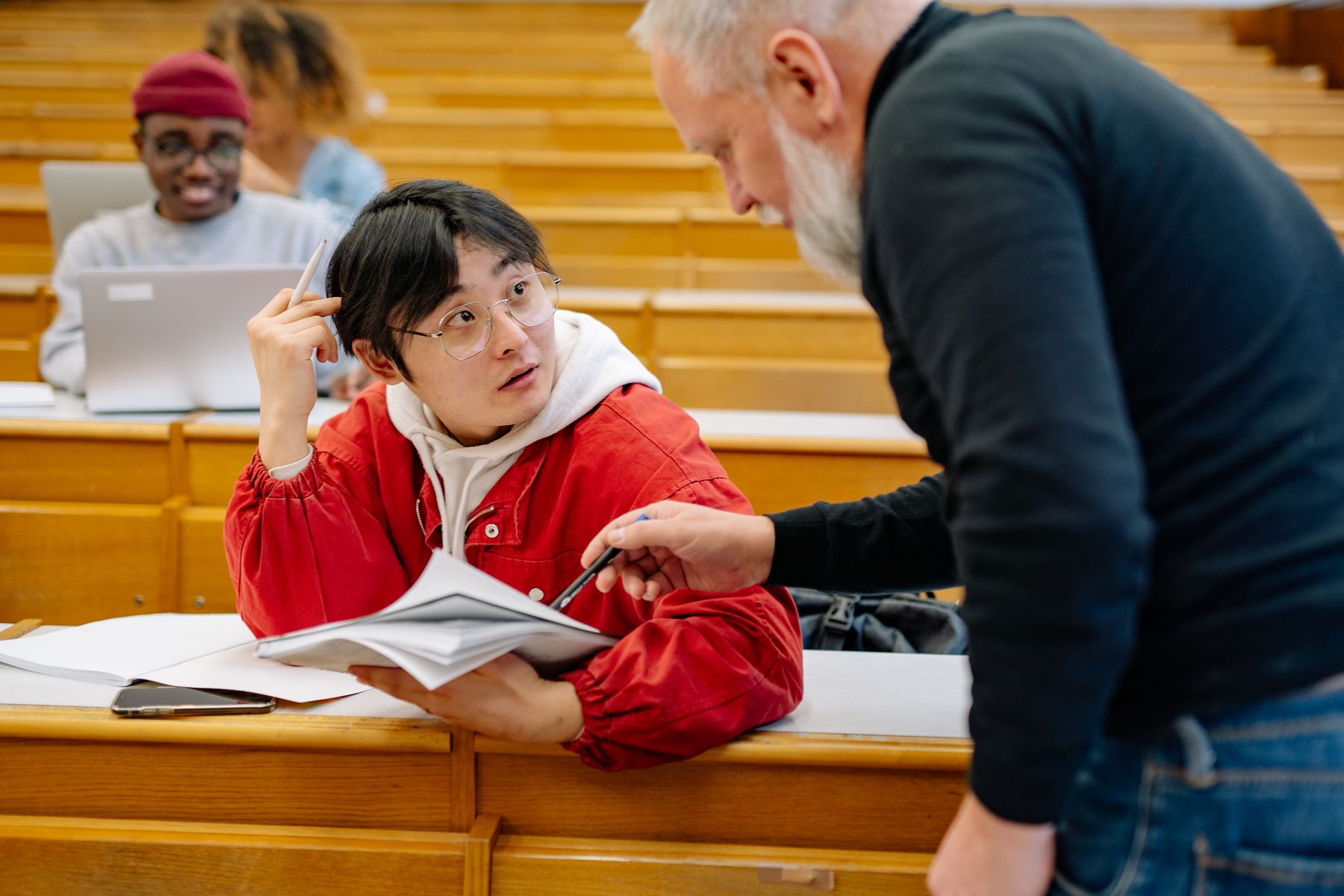Illustrative photograph of a teacher discussing learning with a student
